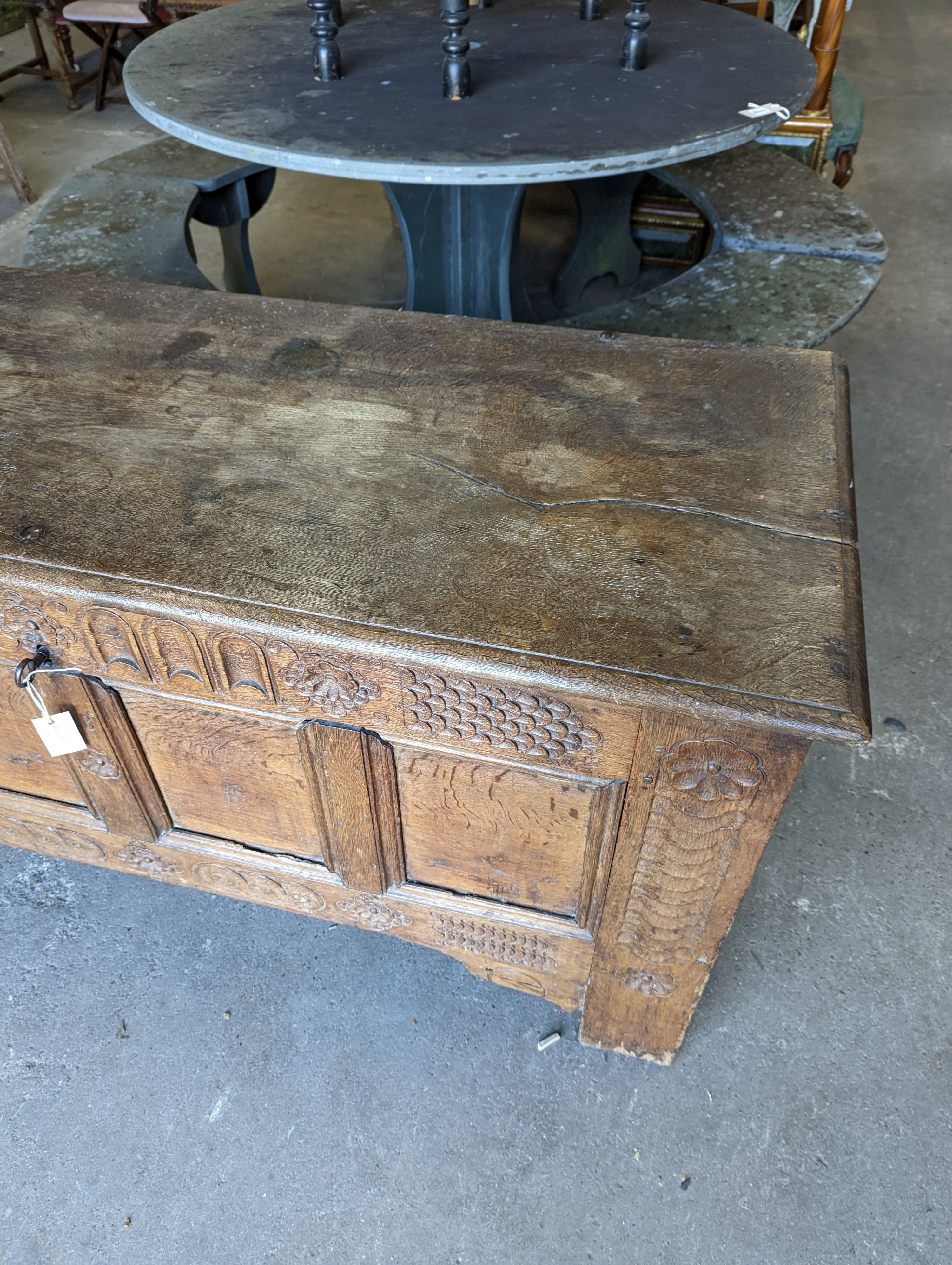 A large 17th century oak panelled coffer, length 147cm, depth 58cm, height 74cm